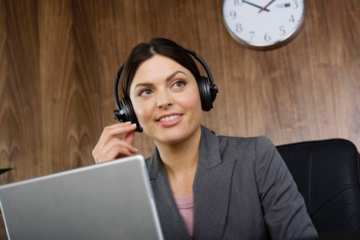 Woman in an office on a headset phone