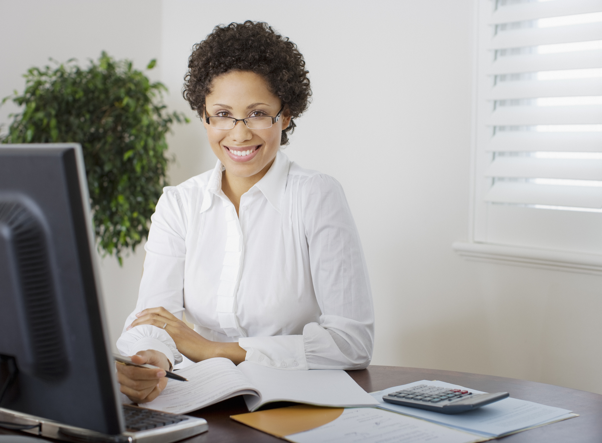 Accountant on a PC looking at the viewer